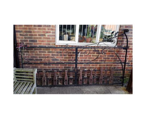 A black painted wrought iron estate gate, with scroll decoration, 293cm wide x 170cm high. 