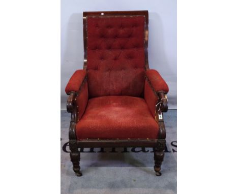 A Victorian mahogany framed armchair with red button back upholstery on tapering supports. 