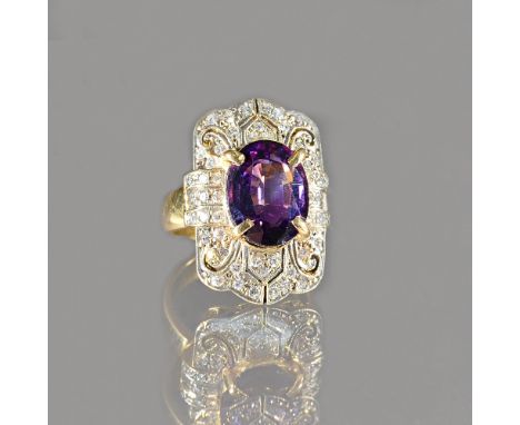 A gold, amethyst and diamond ring, in a curved panel shaped design, claw set with the oval cut amethyst to the centre and oth