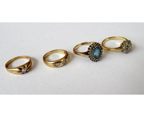 A gold, diamond and colourless gem set cluster ring, detailed 18 CT, gross weight 2.9 gms, a 9ct gold, blue topaz and diamond