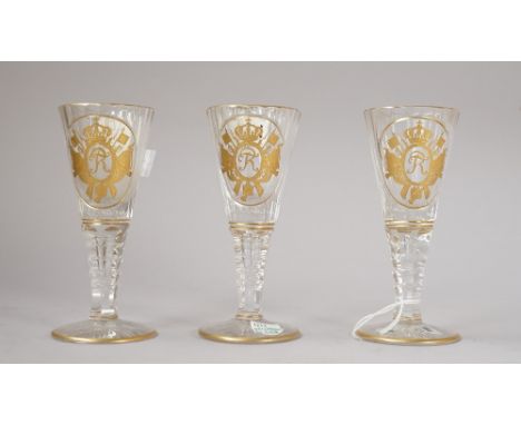 Three Silesian cut and gilt wine glass, early 20th century, the flared and fluted bowls gilt with the FR  monogram of King Fr