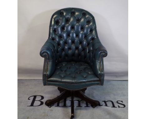 A 20th century Chesterfield style office chair with faux blue leather button back upholstery. 