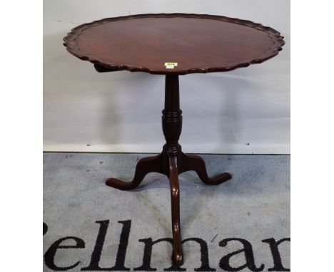 A George III mahogany tripod table, the dished top on three downswept supports, 67cm wide x 69cm high.