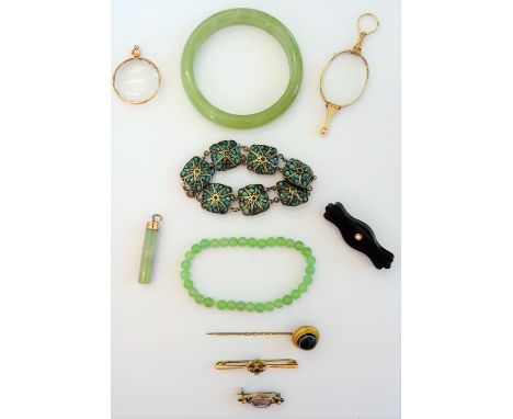 A pair of Victorian folding lorgnettes, fitted with oval lenses and with a loop shaped handle, a green stone bead bracelet, a