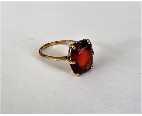 A gold and hessonite garnet single stone ring, claw set with a cushion shaped hessonite garnet, size approx 13.71mm x 10.88mm