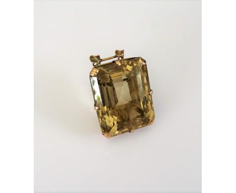 A gold and citrine single stone pendant, claw set with a large rectangular step cut citrine, fitted with a twin loop suspensi