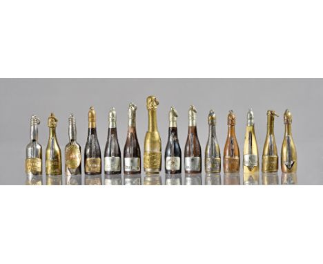 Fourteen novelty cigar cutters and prickers, early 20th century, brass, bone and horn, each modelled as a champagne bottles i