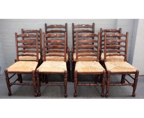 A set of eight 18th century style rush seated ladder back dining chairs, to include a pair of carvers, (8). 