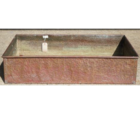 A large rectangular copper planter with beaten finish, 110cm  x 72cm x 24cm.