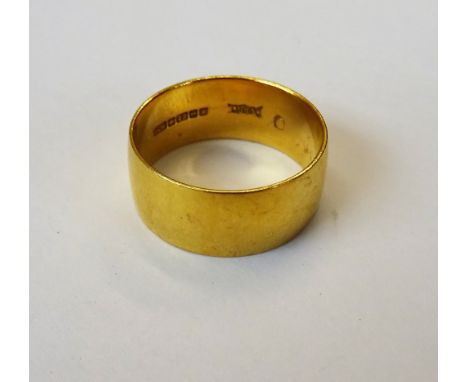 A 22ct gold wide band wedding ring, Birmingham 1970, ring size R, weight 7.7 gms.