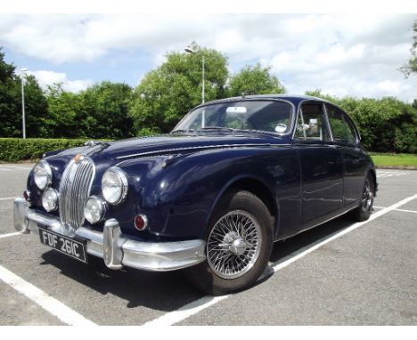 A 1965 Jaguar Mk II 3.4 litre manual overdrive sports saloon, registration number FDF 261C, dark blue. Bill Lyons iconic Mk I