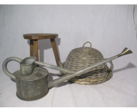 A Haws galvanised watering can, milking stool and wicker tray and cover