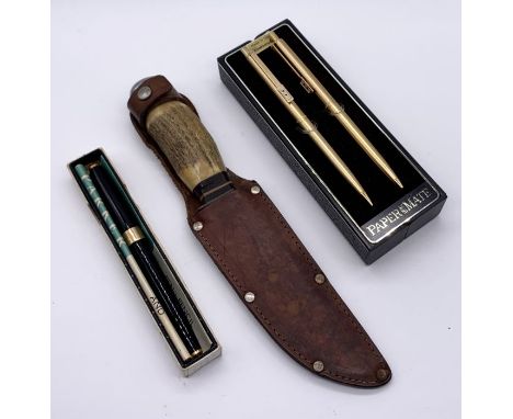 A vintage Carl Schlieper, Solingen, Germany knife in leather sheath along with Parker and Papermate pens