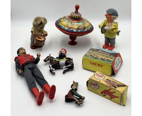 A small collection of toys including two vintage clockwork toys