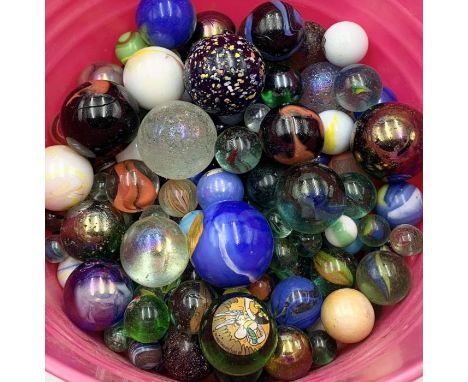 A large quantity of various sized vintage and antique marbles