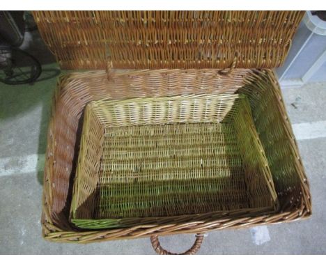 A wicker picnic hamper along with a similar tray.