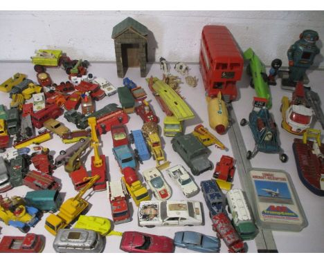 An assortment of vintage play worn toys including die cast Matchbox, Lledo, Dinky etc.   