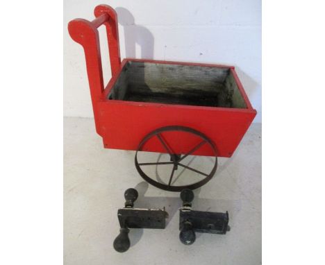 A small wooden planter in the form of a cart along with two pairs of vintage door handles