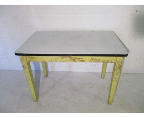 A vintage kitchen table with enamelled top