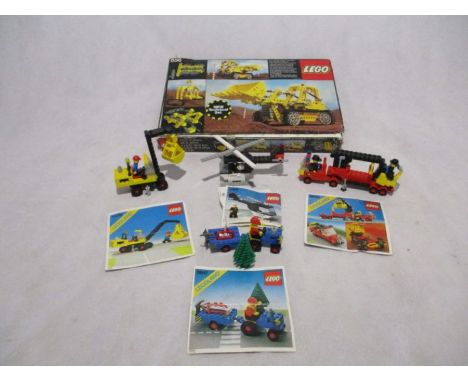 A collection of five sets of vintage Lego including a boxed Bulldozer (856), Classic Town Fire Engine (6690), Highway Repair 