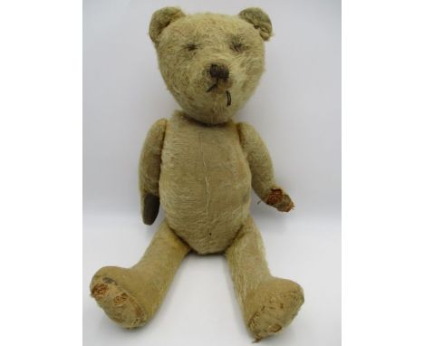 A vintage straw filled teddy bear