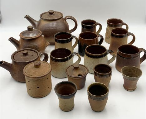 A collection of John Leach Muchelney pottery including teapots, mugs, jars etc.