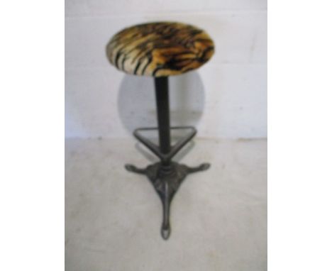 A Victorian style cast iron stool with integral foot rest.