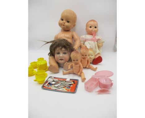 An assortment of vintage dolls and heads (some A/F), also includes a childrens tea set and a Disney happy birthday tray, from