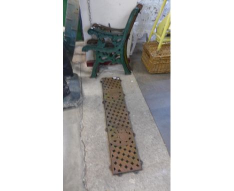A pair of Victorian style cast iron bench ends and one other 