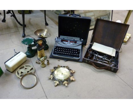 A cast iron doorstop, a set of kitchen scales and weights, typewriter, electric massage machine, Braun digital clock, baromet
