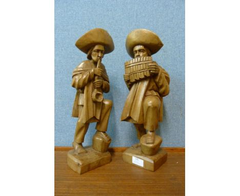 A pair of South American carved wood figures of musicians 