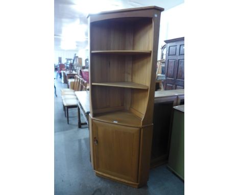 An Ercol blonde corner cupboard 