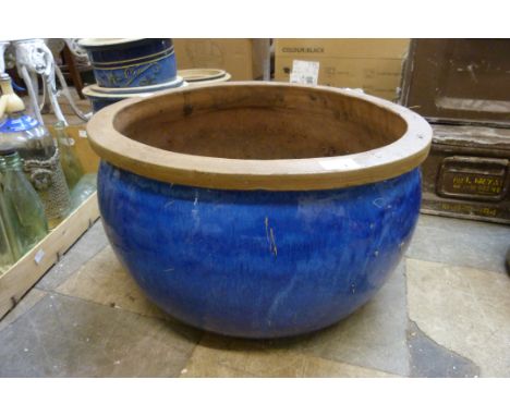 A glazed terracotta planter 