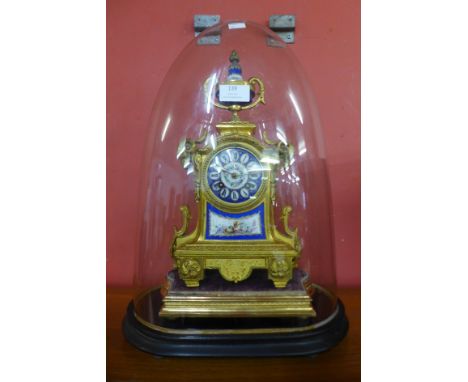 A 19th Century French gilt metal and Sevres style porcelain mantel clock, with ebonised plinth and glass dome, movement signe