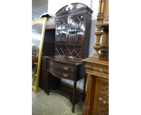 An Edward VII Chippendale Revival carved mahogany serpentine side cabinet 