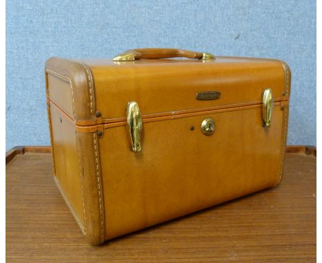 A small brown leather Samsonite trunk 