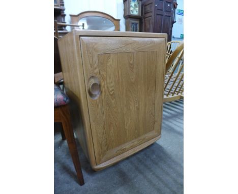 A small Ercol Windsor single door bedside cupboard 