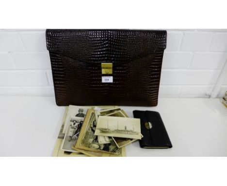 A brown leather wallet satchel containing a quantity of vintage photographs and postcards together with a small black leather