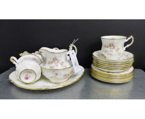 A Paragon Victoriana Rose patterned tea set comprising six cups, six saucers, six side plates, cream jug, sugar bowl and cake