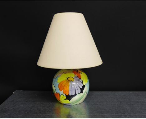 A Grays pottery art deco table lamp painted with flowers in orange, yellow and black in the manner of Susie Cooper