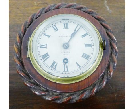 Norie &amp; Wilson, London ships clock, the silvered dial with Roman numerals, in a stained wood surround