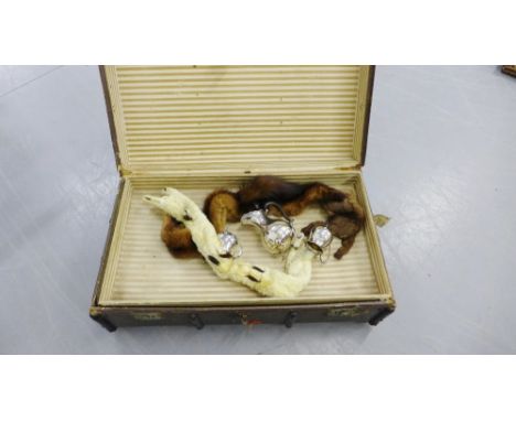 A vintage steamer trunk containing fur stoles and a three piece Epns teaset (a lot) 