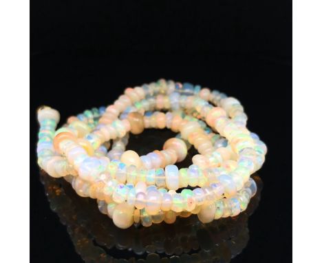 AN OPAL BEADED NECKLACE. VINTAGE OPAL ROUNDEL BEADS RECENTLY RESTRUNG. NECKLACE LENGTH 76cms.