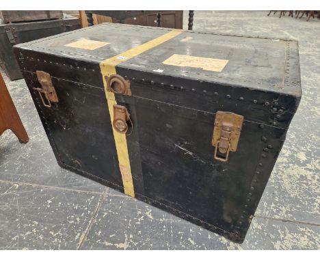 A METAL BOUND BLACK TRUNK WITH TWO LEATHER HANDLES
