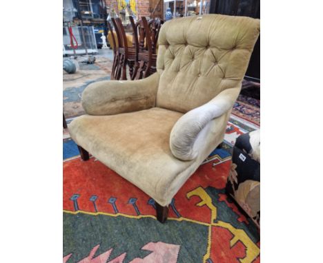 MANNER OF HOWARD &amp; SONS, A MAHOGANY ARMCHAIR BUTTON UPHOLSTERED IN GOLDEN VELVET, THE SQUARE SECTIONED LEGS WITH BRASS CA