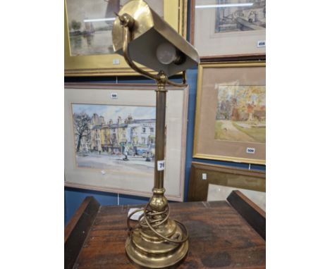 A BRASS TABLE LAMP WITH DIRECTIONAL HALF ROUND SHADE, CYLINDRICAL COLUMN AND STEPPED CIRCULAR FOOT.   H 52cms.