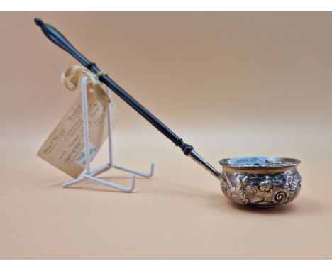 A TODDY LADLE INSET WITH A QUEEN ANNE COIN AND WITH AN EBONY HANDLE