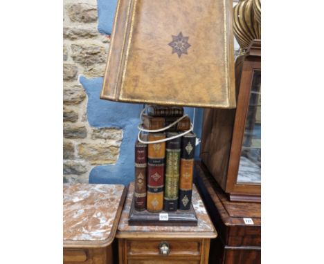 A TABLE LAMP SUPPORTED ON FOUR LARGE BOOKS AND TWO SMALLER VOLUMES, TO THE TOP OF THE SHADE.   H 80cms.