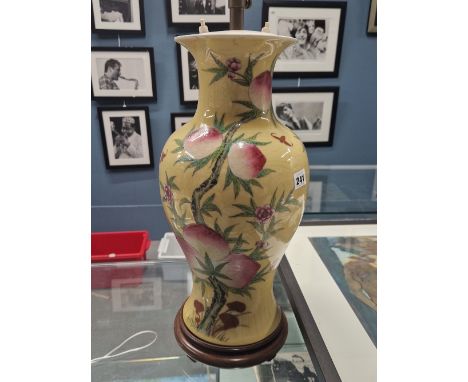 A LARGE ORIENTAL VASE WITH YELLOW GROUND AND FRUIT TREE DECORATION- LATER MOUNTED AS A LAMP.