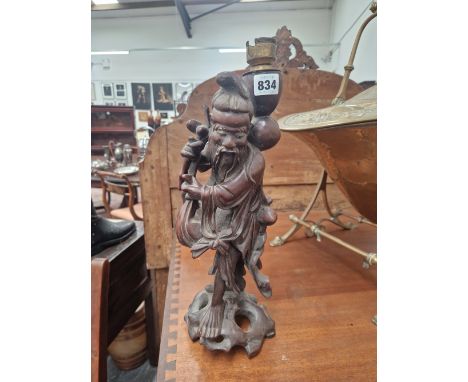 A CHINESE CARVED WOOD FIGURE OF A DAOIST IMMORTAL AS A TABLE LAMP